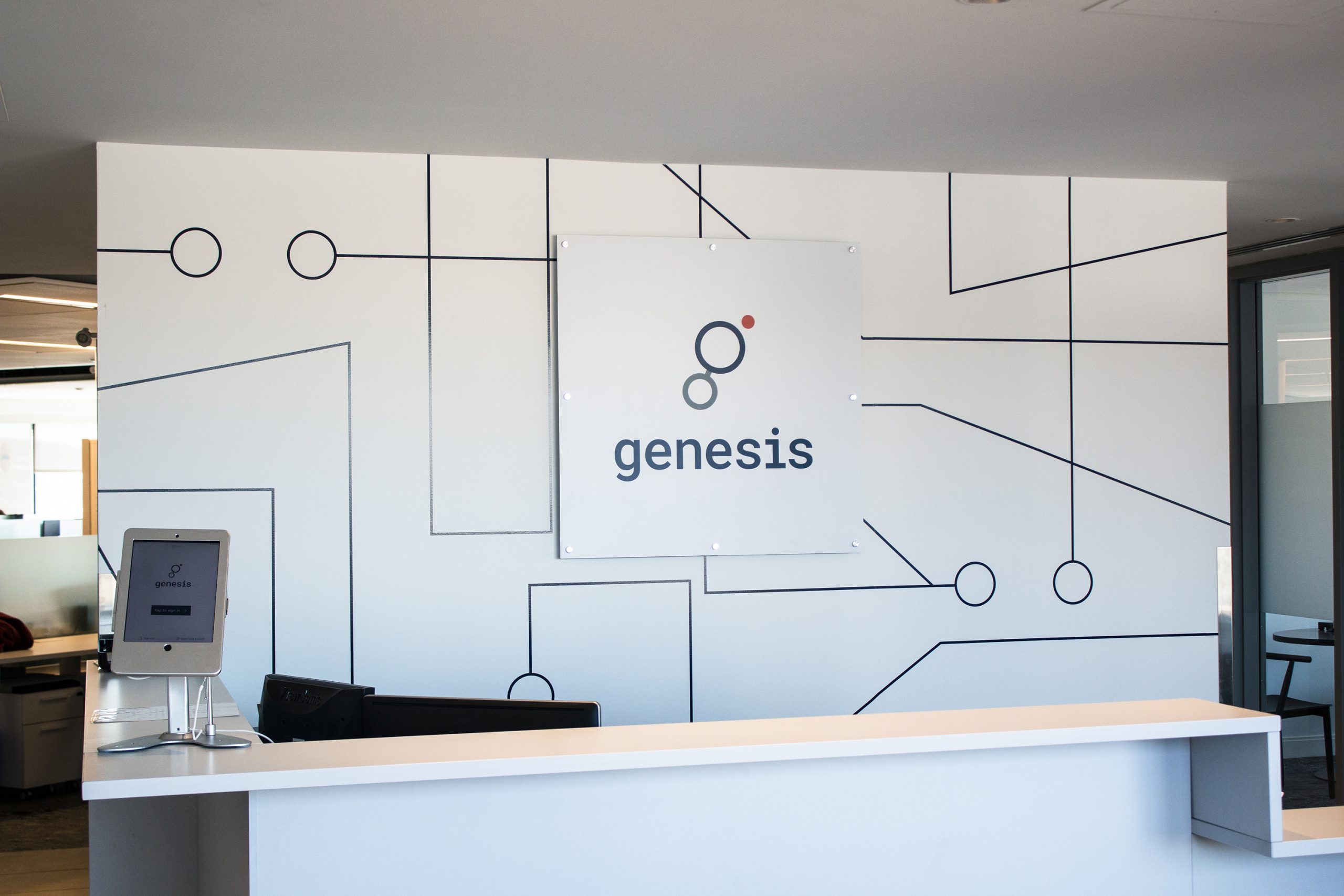 The Genesis reception area with a Genesis sign on the back white wall